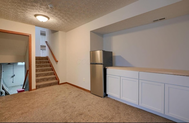 7265 Bromfield Dr, Canal Winchester, OH 43110 - finished basement with freestanding refrigerator, light colored carpet, and stairs