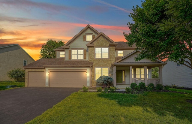 7265 Bromfield Dr, Canal Winchester, OH 43110 - traditional home with a porch, stone siding, driveway, a front yard, and a garage