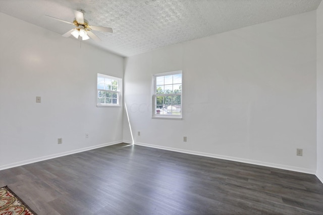 empty room with a textured ceiling, ceiling fan, and dark wood-type flooring