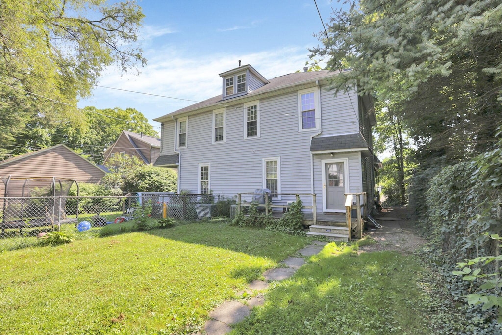 back of house with a yard