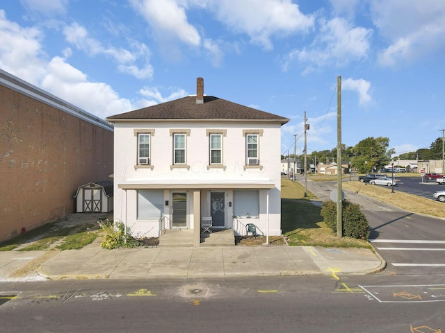 view of front facade with a shed