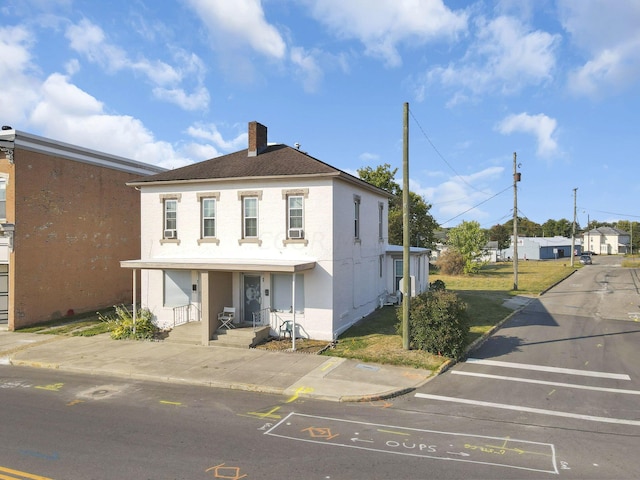 45 S 5th St, Newark, OH 43055 - view of front of house with a chimney, uncovered parking, stucco siding, and cooling unit