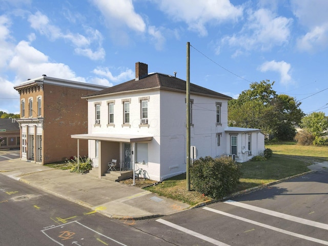 view of side of home with a yard