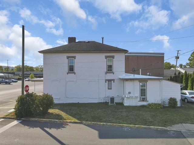 view of home's exterior featuring a lawn and cooling unit