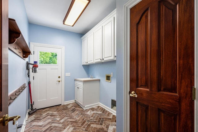 clothes washing area featuring washer hookup, cabinets, and sink