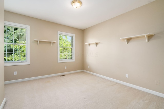 empty room featuring light colored carpet