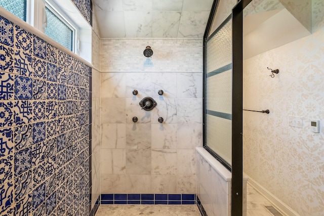 bathroom with a tile shower