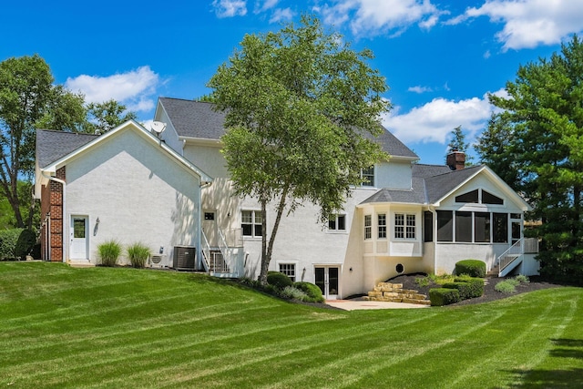 back of house featuring a sunroom and a yard