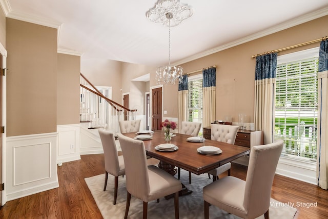 dining space with a chandelier, dark hardwood / wood-style flooring, and ornamental molding