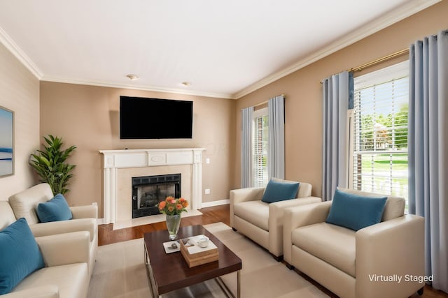 living room with crown molding, a high end fireplace, and light hardwood / wood-style floors