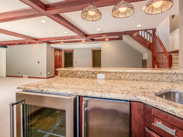 kitchen with carpet, coffered ceiling, beverage cooler, decorative light fixtures, and beamed ceiling