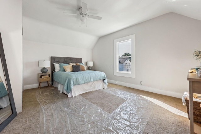 carpeted bedroom with ceiling fan and lofted ceiling