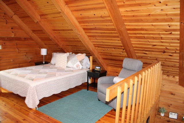 unfurnished bedroom featuring lofted ceiling with beams, wood walls, hardwood / wood-style floors, and wooden ceiling