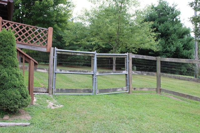 view of gate featuring a lawn