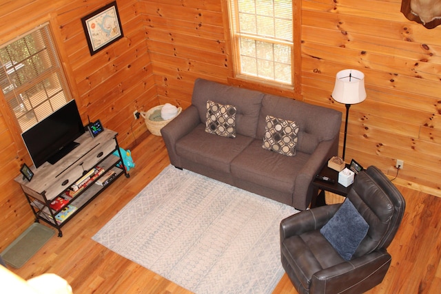 living room featuring wood-type flooring and wood walls