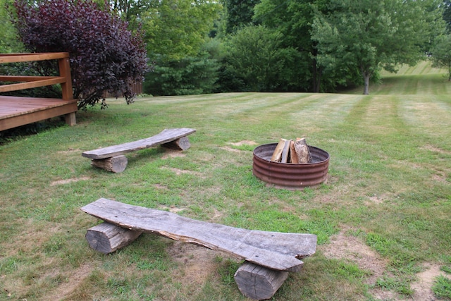 view of yard featuring an outdoor fire pit