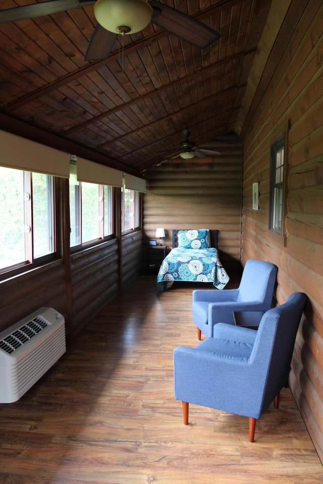 sunroom / solarium featuring lofted ceiling, a wall unit AC, wooden ceiling, and ceiling fan