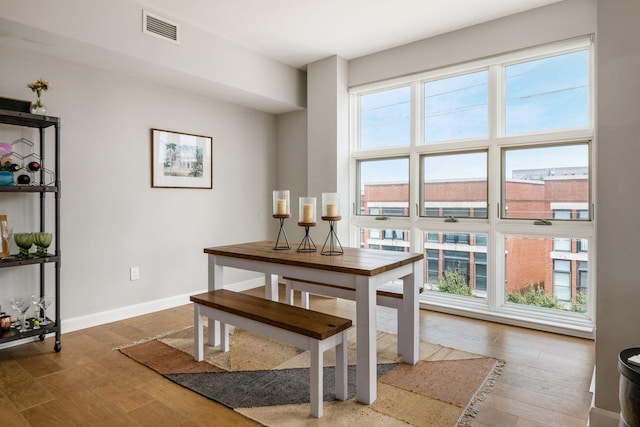 dining space with hardwood / wood-style floors and plenty of natural light