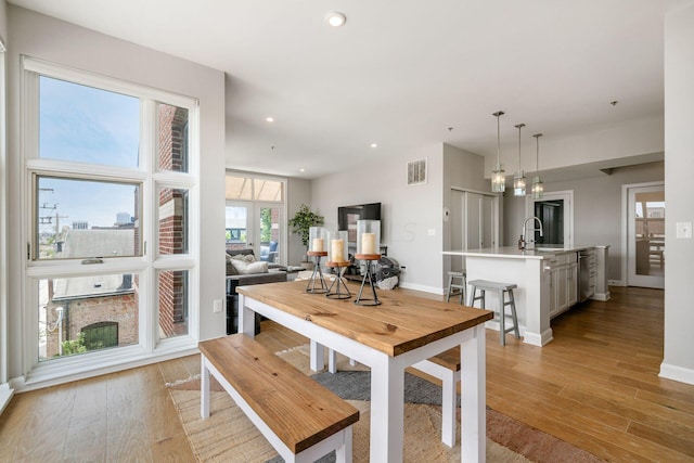 dining space featuring light hardwood / wood-style floors and sink