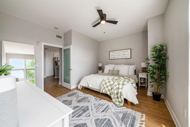 bedroom with ceiling fan and hardwood / wood-style floors