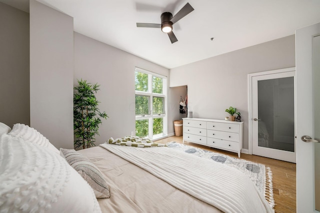 bedroom with ceiling fan and light hardwood / wood-style flooring