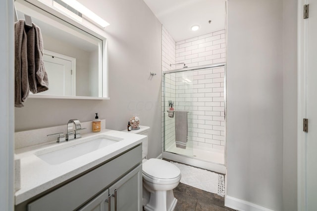 bathroom featuring toilet, vanity, tile patterned floors, and walk in shower