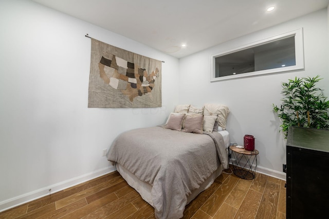 bedroom with dark wood-type flooring