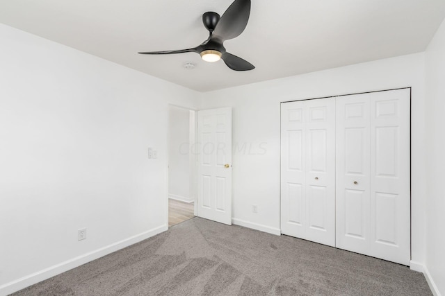 unfurnished bedroom with ceiling fan, light carpet, and a closet