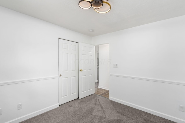 unfurnished bedroom featuring carpet flooring and a closet