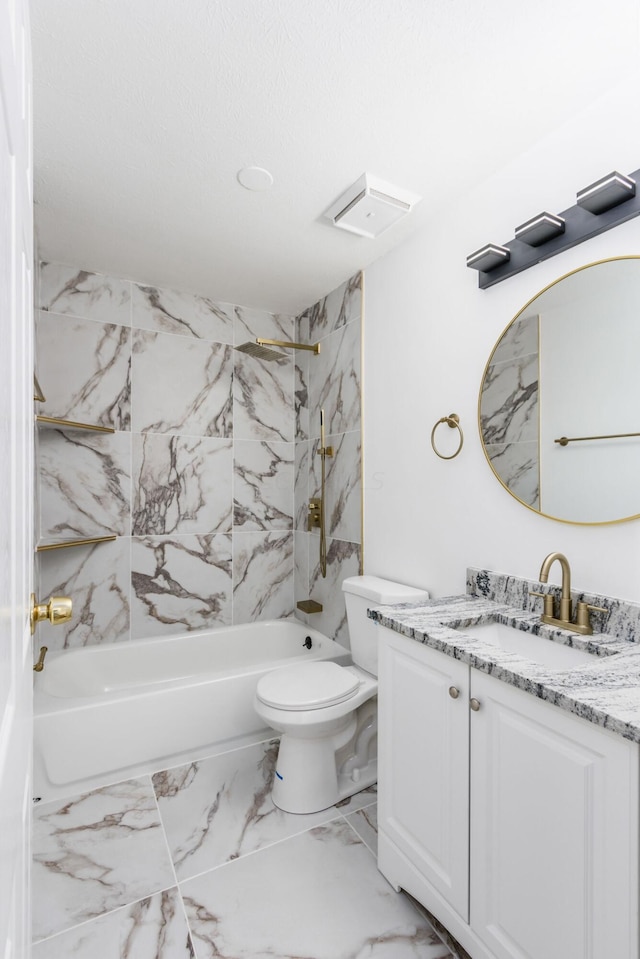 full bathroom featuring vanity, tiled shower / bath combo, and toilet