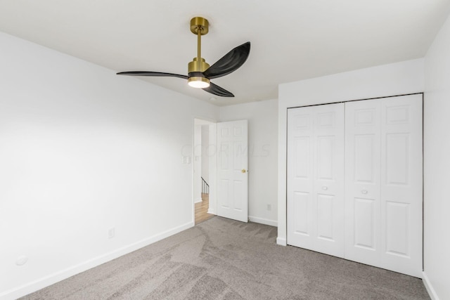 unfurnished bedroom featuring ceiling fan, a closet, and carpet floors