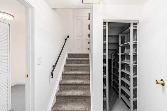 stairway featuring concrete flooring