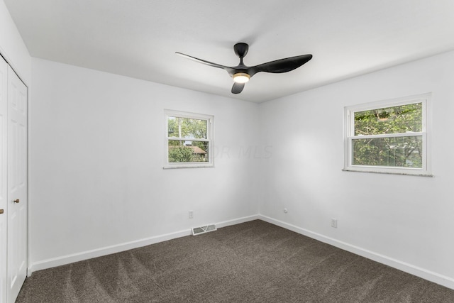 carpeted empty room featuring ceiling fan