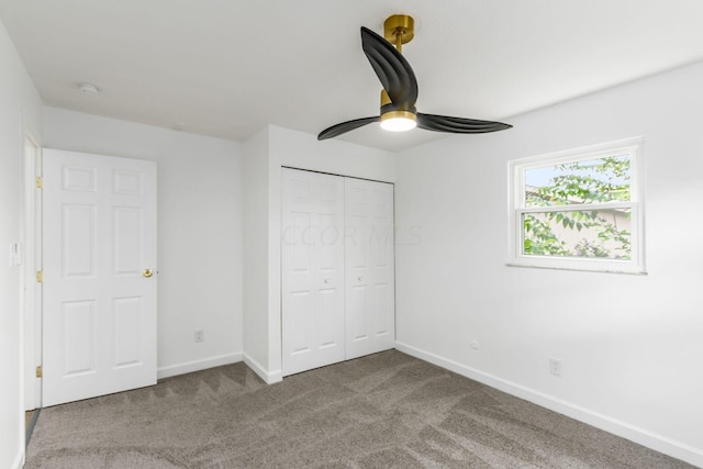 unfurnished bedroom featuring ceiling fan, a closet, and carpet floors