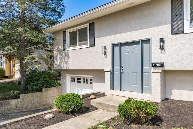 doorway to property with a garage