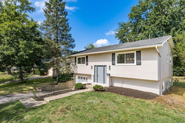 split foyer home featuring a garage and a front lawn