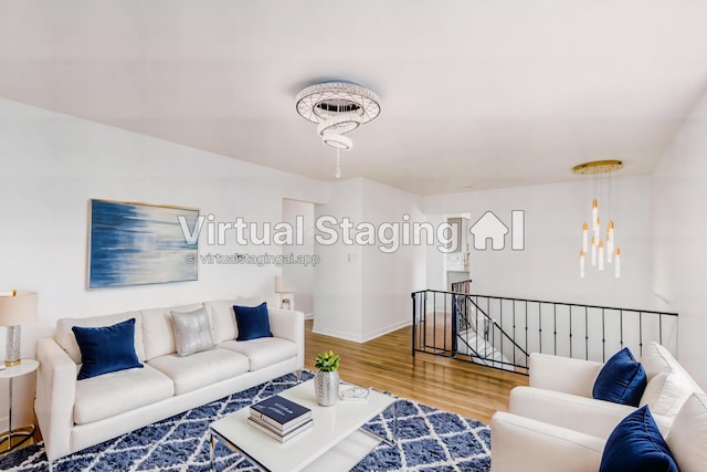 living room with a chandelier and wood-type flooring