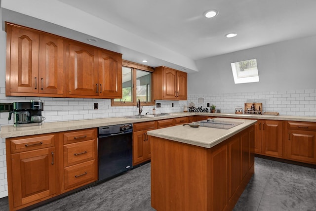 kitchen featuring dishwasher, dark tile patterned flooring, sink, a skylight, and a kitchen island