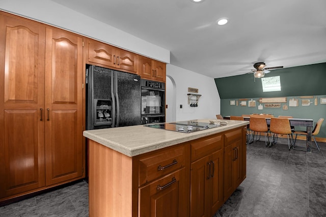 kitchen featuring a kitchen island, ceiling fan, and black appliances