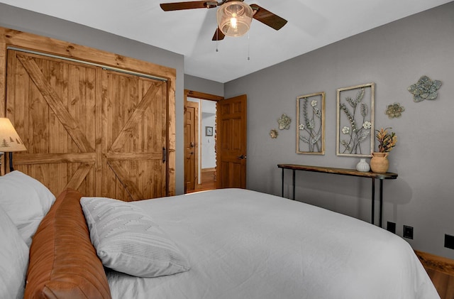 bedroom with ceiling fan and a closet