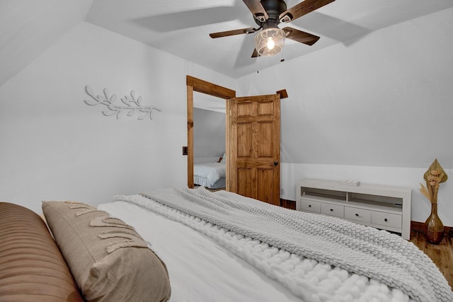 bedroom with hardwood / wood-style flooring, ceiling fan, and lofted ceiling