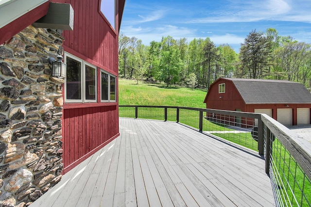 wooden deck featuring an outbuilding and a yard