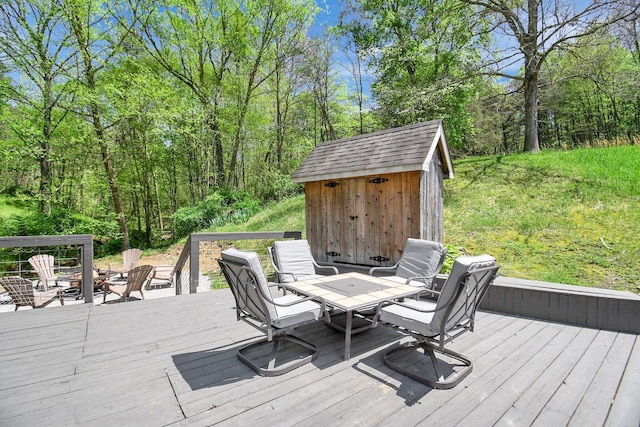 wooden deck featuring an outdoor fire pit