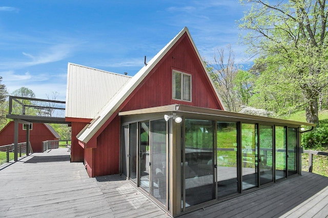 wooden deck with a sunroom