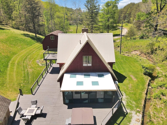 rear view of property featuring a wooden deck