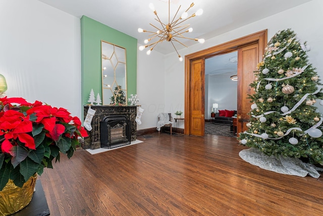 living room with dark hardwood / wood-style floors and an inviting chandelier