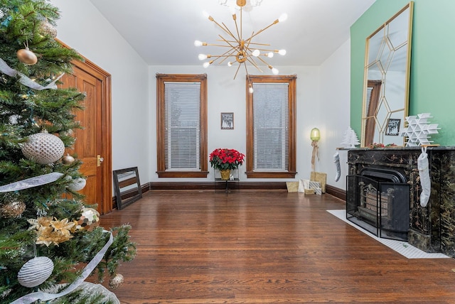 sitting room with dark hardwood / wood-style flooring and a notable chandelier