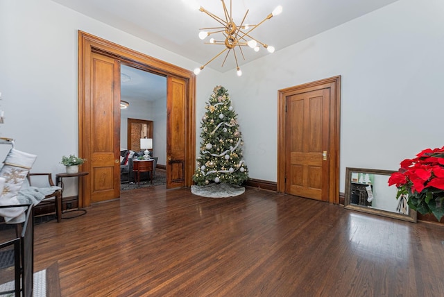 sitting room featuring a chandelier and dark hardwood / wood-style flooring