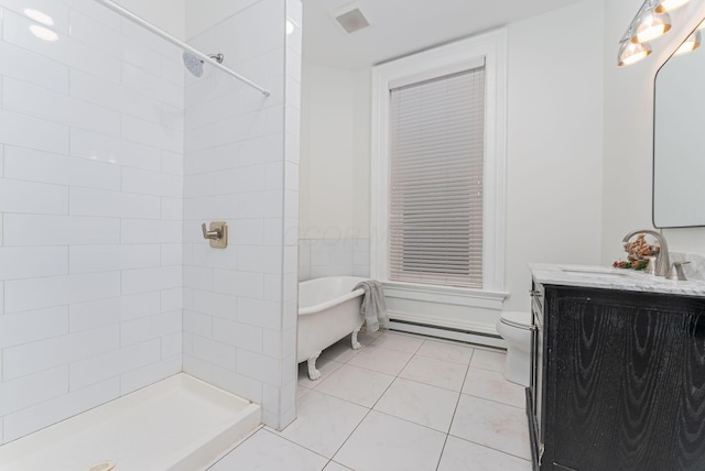 bathroom featuring tiled shower, tile patterned flooring, vanity, and toilet