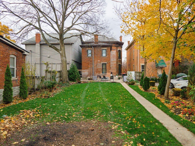 rear view of house with a yard